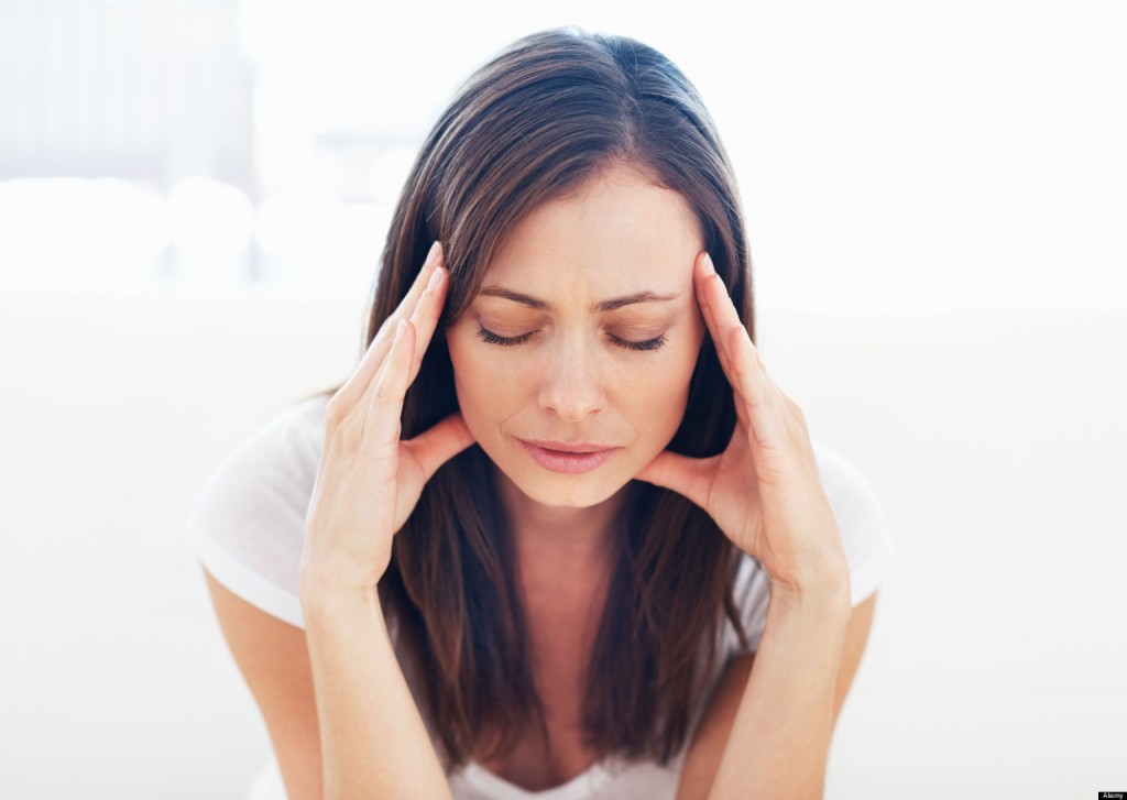 Portrait of stressed woman having head pain