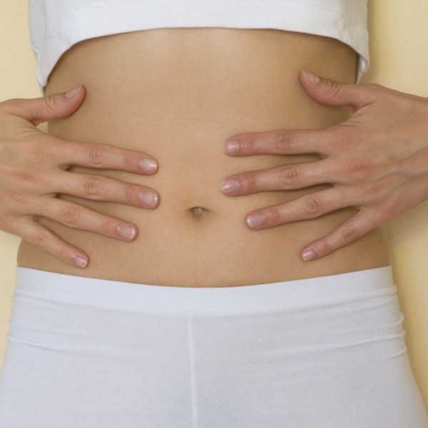 Woman touching stomach